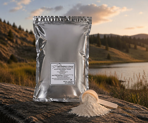 Silver package of 'My Energy Edge' powder with a spoonful of powder on a rock with a scenic background.